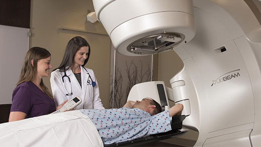 Photo of two providers caring for patient in a TrueBeam machine at Methodist Jennie Edmundson Cancer Center in Council Bluffs, Iowa.